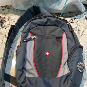Gray and red Swiss gear single strap back pack.